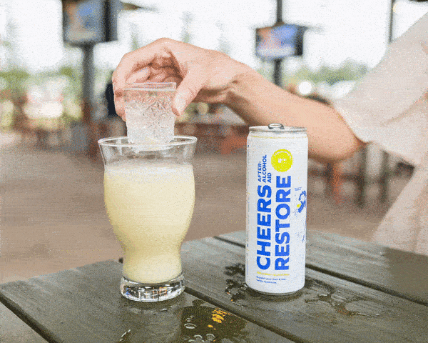 Can of cheers restore and a sake bomb glass