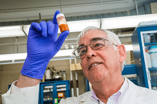 Lab technician studying a phial