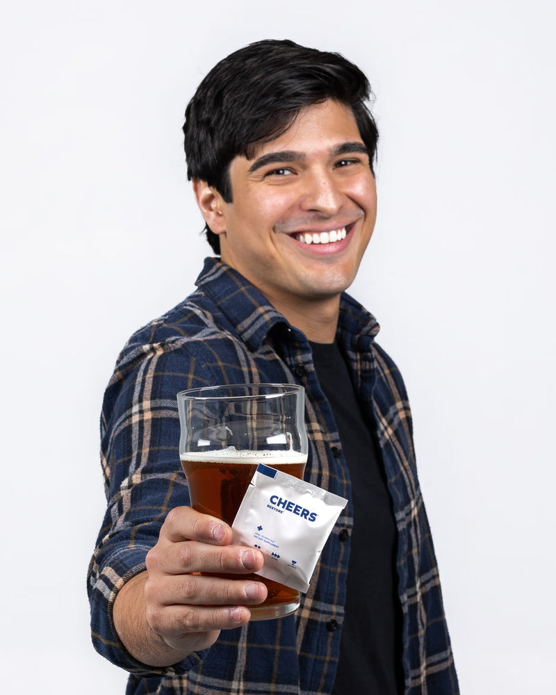 Man holding a beer and cheers restore