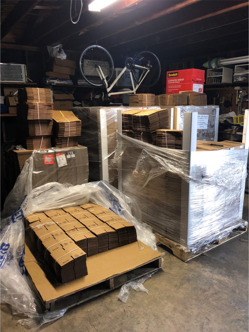 A pallet of Cheers packaging in a garage