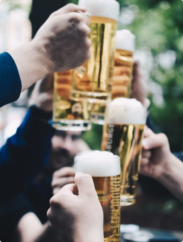 People clinking beer mugs together